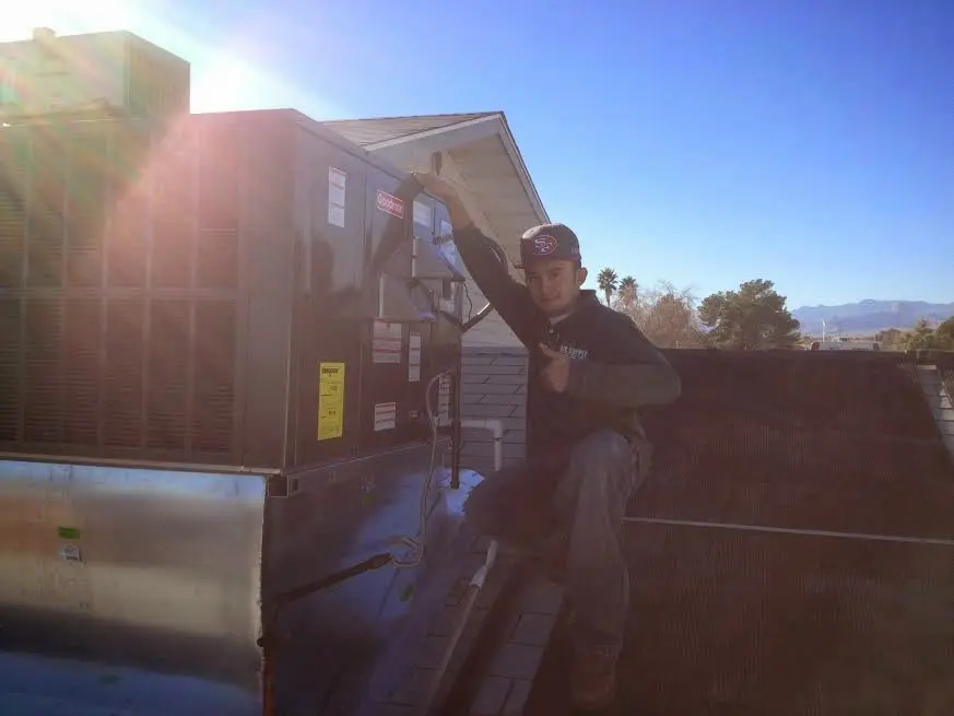 HVAC technician performing Boiler Repair on a rooftop unit in Travilah